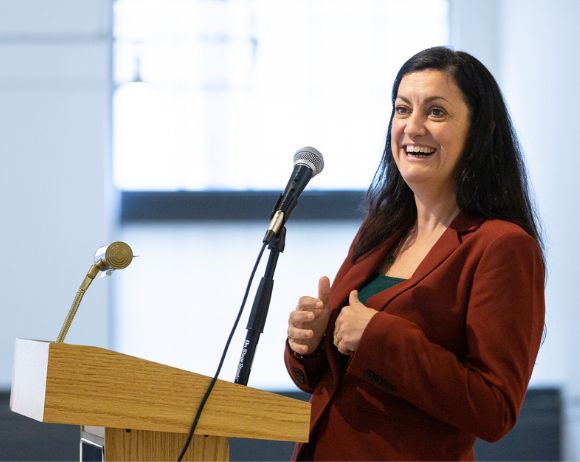 Caitlín Doherty speaking at a podium