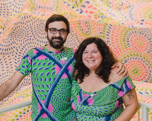 joey and felici standing in front of their exhibition