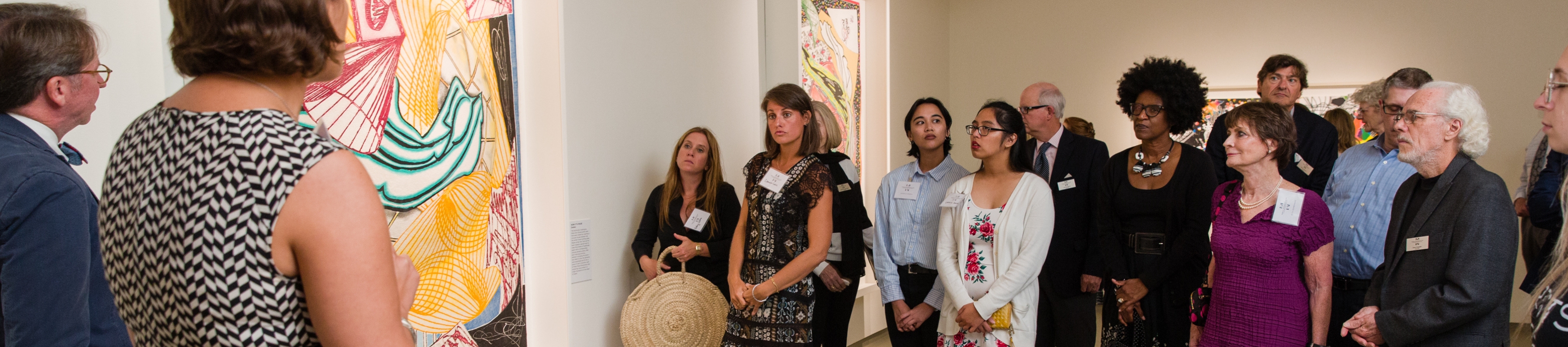 a group of patrons and board members enjoys a tour of Frank Stella work on display at MOCA Jacksonville