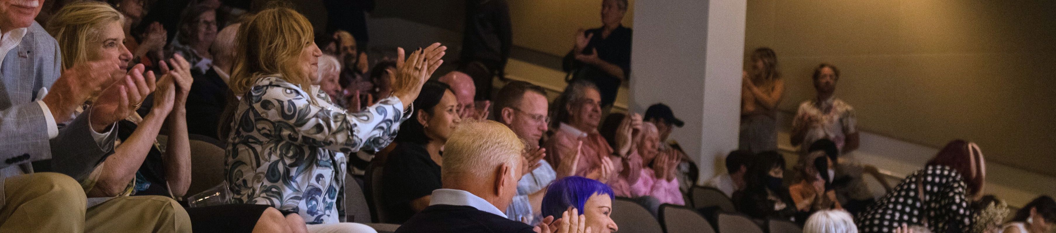 an audience in the MOCA Theater applauds