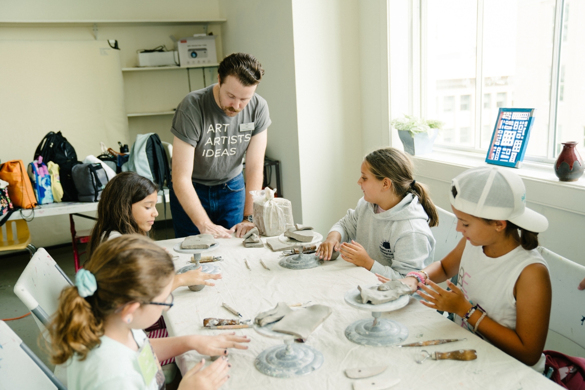 A MOCA educator teaching students about ceramics during Summer Camp @ MOCA