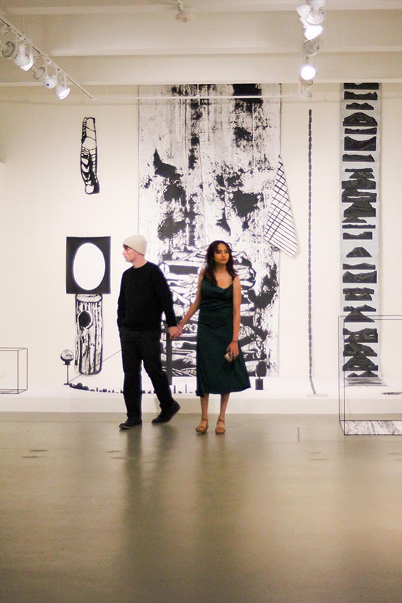 two teens walking around the gallery