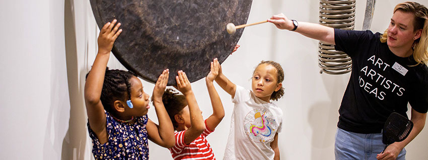 Ambassador with kids in John Cage exhibit