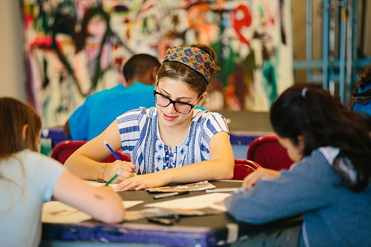 three girls drawing