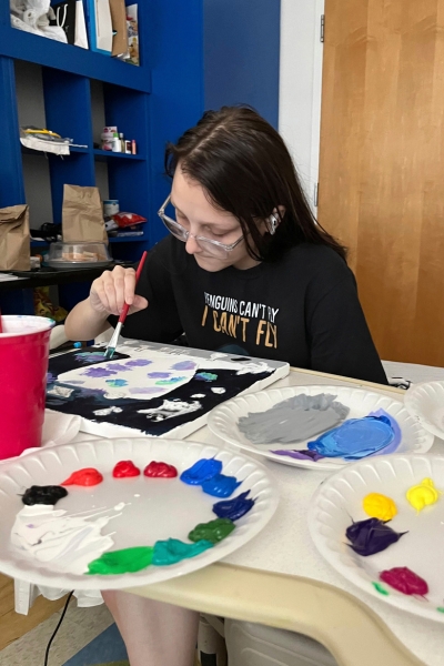 a teen working on a painting