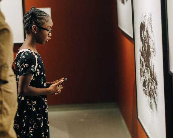 young girl looking at artwork