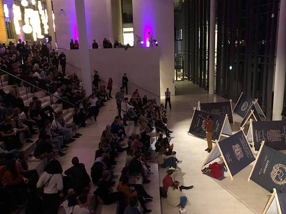 group of people looking at camp by Khalid Albaih