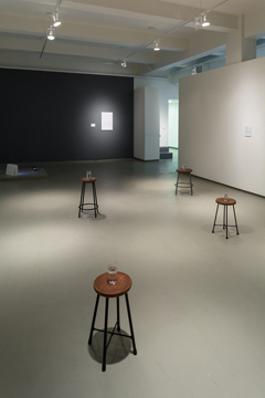 four stools with water glasses on top