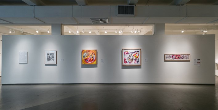 a wall with four pieces of artwork from the Time Zones exhibit