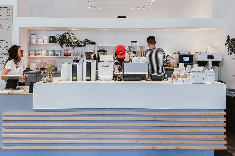 the Setlan Coffee Co. counter with employees busy working behind it